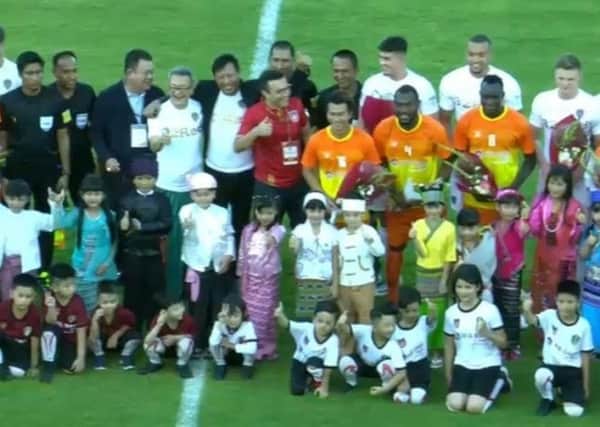 BRINGING JOY: Radrizzani, pictured centre, on the pitch before Leeds friendly defeat to the Myanmar National League All-Stars.