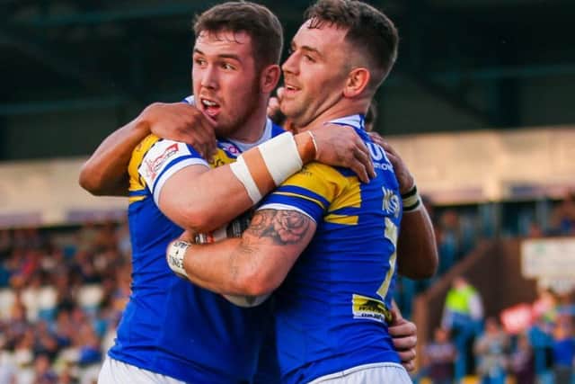 Richie Myler, right, celebrates his try with Cameron Smith.