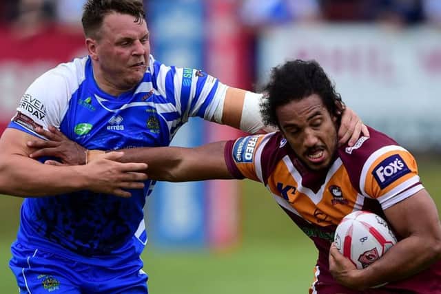 Joel Farrell hands off Halifax's Edward Barber.