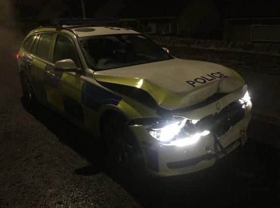 Damage caused to the police car after it was rammed repeatedly by another vehicle in Bradford.