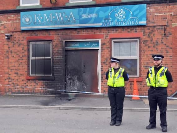 Officers standing guard outside theJamia Masjid Abu Huraira Mosque in Beeston following yesterday's arson attack. Picture: Gary Longbottom