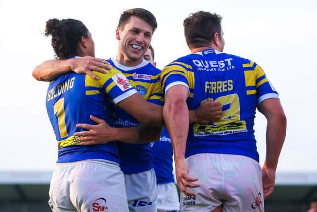 Ashton Golding celebrates his try against Leigh with Tom Briscoe and Brett Ferres.