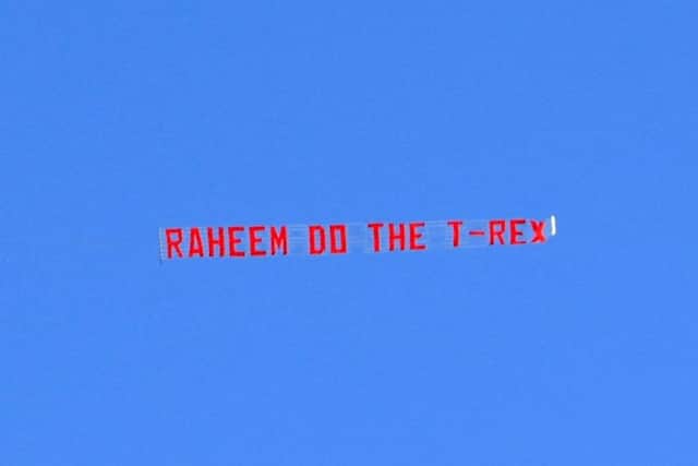 The banner implores Raheem Sterling to do a T-rex goal celebration