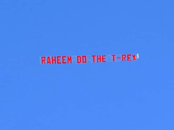 The banner implores Raheem Sterling to do a T-rex goal celebration