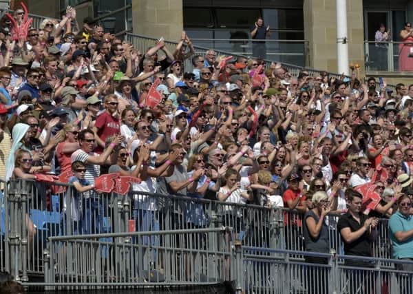 The crowds cheer home the participants in Millennium Square, Leeds.