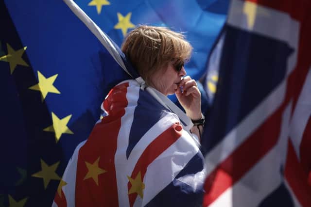 An anti-Brexit demonstrator looks pensive during a protest outside the Houses of Parliament on June 11, 2018 . The EU withdrawal bill returns to the House of Commons tomorrow for the first of two sessions in which MP's will consider amendments imposed by the Lords, and another set of fresh amendments. (Photo by Dan Kitwood/Getty Images)