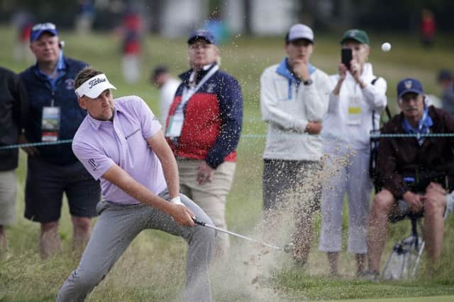 TOUGH DAY: Ian Poulter plays a shot from a bunker on the sixth hole during the second round of the US Open Picture: AP/Seth Wenig