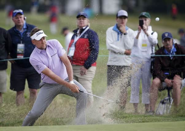 TOUGH DAY: Ian Poulter plays a shot from a bunker on the sixth hole during the second round of the US Open Picture: AP/Seth Wenig