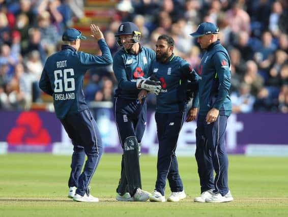 England's Adil Rashid (centre) celebrates with Joe Root (left) Jos Buttler (second left) and Jason Roy (right) after taking the wicket of Australia's Aaron Finch in Cardiff. Picture: Nigel French/PA
