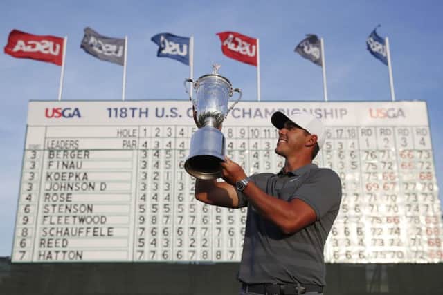 Winner: Brooks Koepka holds up the tophy after retaining his US Open title. Picture: AP Photo/Carolyn Kaster