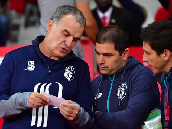 Marcelo Bielsa talks to backroom staff Pablo Quiroga and Diego Reyes during his time at Lille.