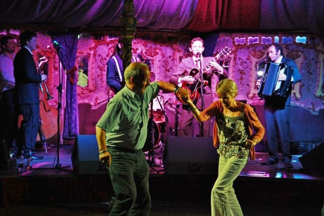 A couple dance to Benoit Viellefon and His Hot Club.