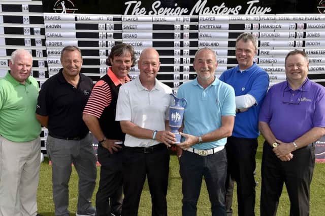 Mark Booth, centre, winner of the inaugural Leeds Seniors Masters last year, receives the trophy from Nigel Sweet.