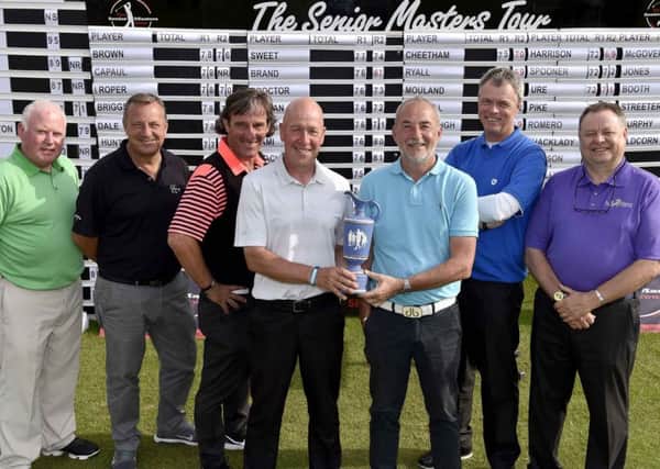 Mark Booth, centre, winner of the inaugural Leeds Seniors Masters last year, receives the trophy from Nigel Sweet.