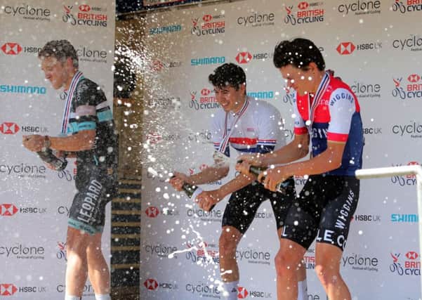 Charlie Tanfield, centre, sprays Charlie Quarterman, left, and Thomas Pidcock with champagne after the Under-23s race at the HSBC UK National Road Championships Time Trial (Picture: Richard Sellers/PA Wire).