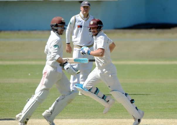 Rory Burns and Scott Borthwick on their way to a second-wicket stand of 47 that helped County Championship Division One leaders Surrey secure a seven-wicket victory over Yorkshire at Scarborough (Picture: Dave Williams).