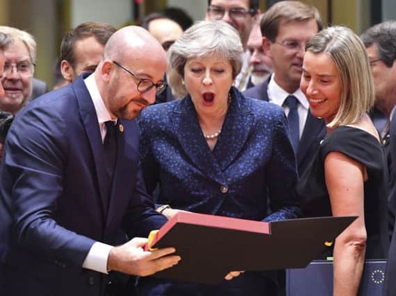 Theresa May is presented with a Belgium football shirt by the country's PM Charles Michel at last week's European Council summit, at which little progress was made in Brexit talks.