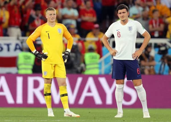 England defender Harry Maguire, right, and goalkeeper Jordan Pickford look dejected after their defeat to Belgium in Kaliningrad (Picture: Owen Humphreys/PA Wire).