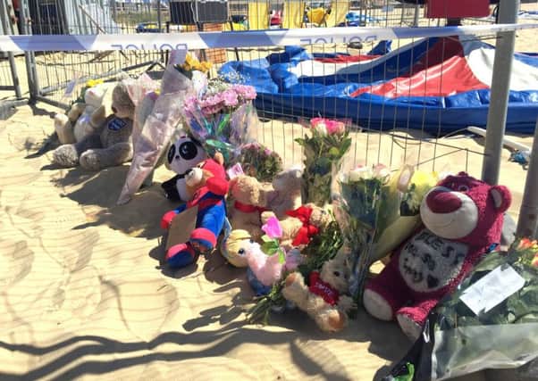 Floral tributes left at Gorleston beach in Norfolk where a girl was fatally thrown from an inflatable. PIC: PA