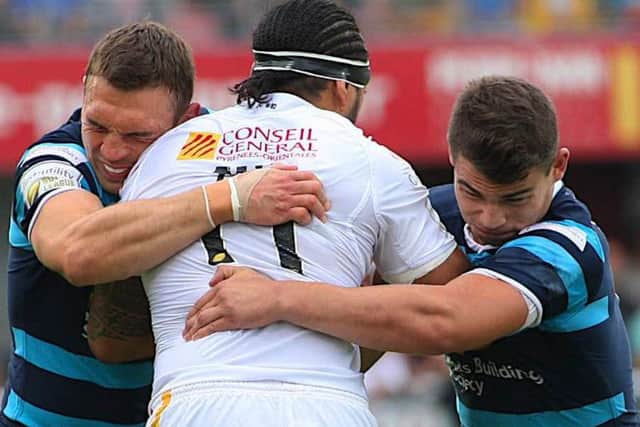 TOGETHER AGAIN: Kevin Sinfield and Stevie Ward combine to stop Catalans Zeb Taia back in 2015.