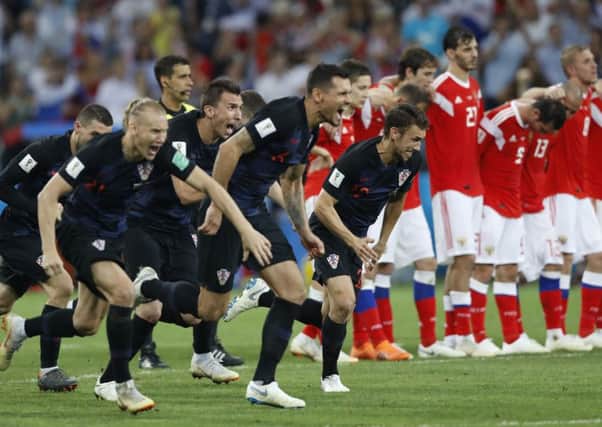 Croatia players celebrate after beating hosts Russia on penalties. Picture: AP/Darko Bandic