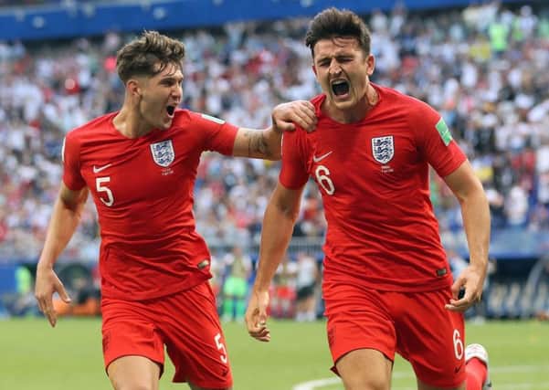 England's Harry Maguire, right, celebrates with John Stones after scoring their first goal in a 2-0 World Cup quarter-final win over Sweden (Picture: Owen Humphreys/PA Wire).