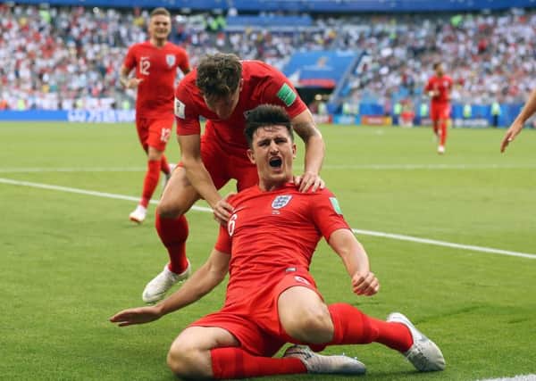 England's Harry Maguire, from Sheffield, celebrates scoring his side's first goal of the game with John Stones, from Barnsley, during the FIFA World Cup, quarter-final with Sweden (Picture: Owen Humphreys/PA)