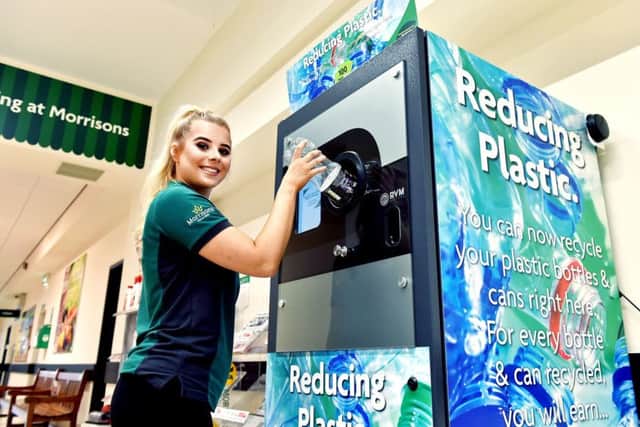 A woman uses a reverse vending machine for the return of single-use plastic bottles, which is being trialed at the supermarket chain to reduce their impact on the environment. PIC: PA