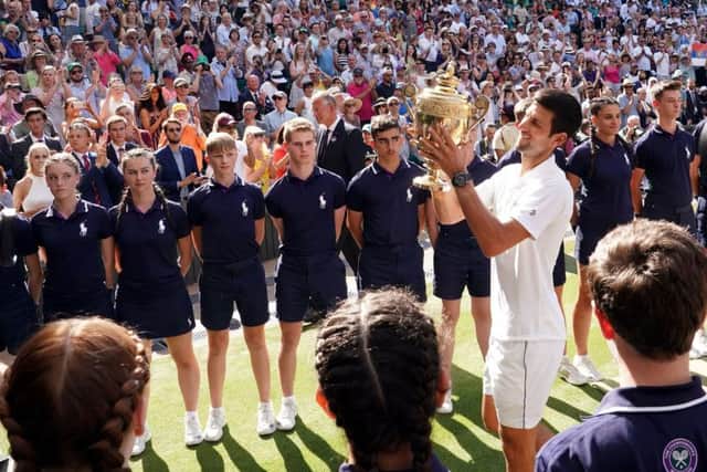 Novak Djokovic is given a guard of honour by the ballboys and ballgirls on Centre Court (Picture: John Walton/PA Wire).