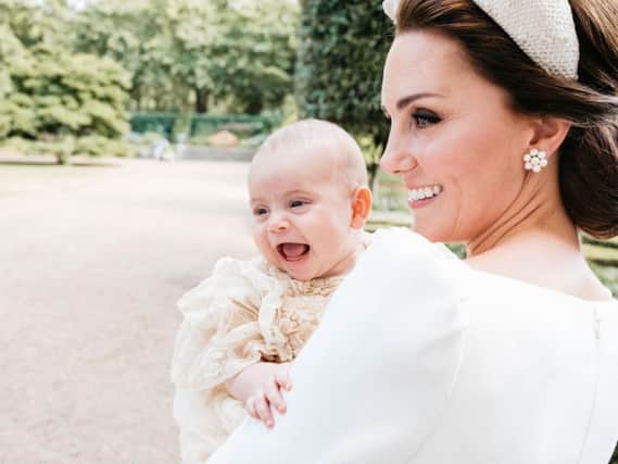 The Duke and Duchess of Cambridge have released this additional photograph taken Monday 9th July by Matt Porteous in the garden at Clarence House, following Prince Louis's baptism at the Chapel Royal, St. James's Palace. PA