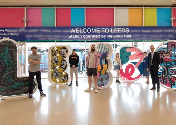 NEW-LOOK: The artists and their colourful letters which spell out the city at Leeds Train Station.