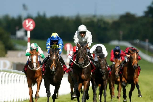 Dee Ex Bee, under the stewardship of pilot Silvestre de Sousa (centre), winning at Goodwood last year. PIC: Paul Harding/PA Wire