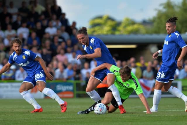 Gaetano Berardi, Luke Ayling and Kalvin Phillips challenge Forest Green's Dayle Grub for the ball.