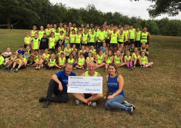 SUPPORT: Rothwell Harriers hand over the funds raised.