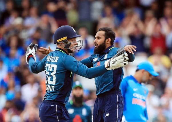 England's Adil Rashid celebrates with Jos Buttler after taking a wicket against India at Headingley on Tuesday. Picture: Danny Lawson/PA