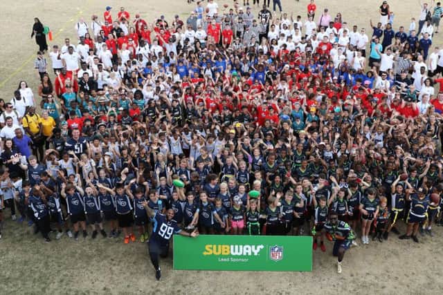 One thousand children participated in a NFL Flag Summer Bowl with NFL players.