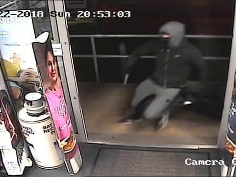 A CCTV image capturing the robbery in action.