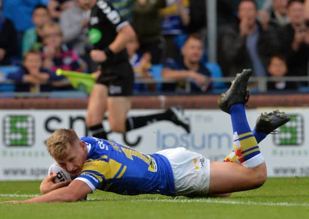 Brad Dwyer slides over for the Rhinos' opening try.
