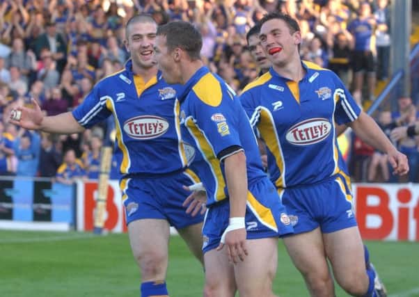 Danny McGuire celebrates scoring his first try against St Helens with Matt Diskin and Kevin Sinfield.