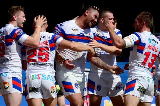 David Fifita, of Wakefield Trinity, celebrates after scoring a try.