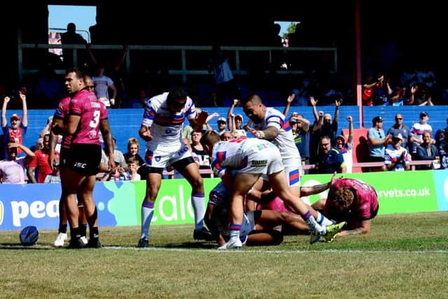 Celebrations after Reece Lyne, of Wakefield Trinity, scores a try.