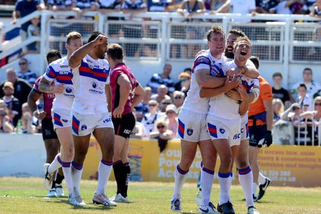 Wakefield's Jacob Miller celebrates after scoring a try against Hull.