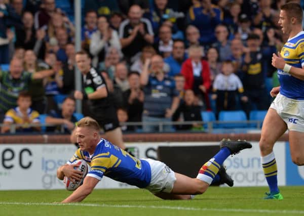 Brad Dwyer slides over for the Rhinos' opening try against Widnes Vikings.