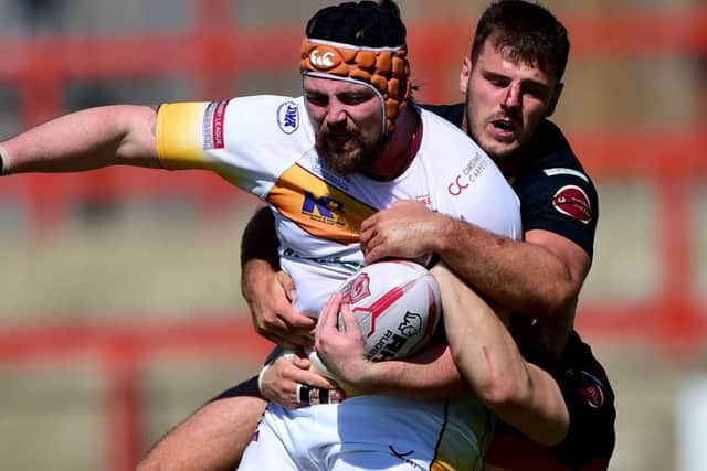 Dewsbury's Joe Arundel tackles Batley's Michael Ward.