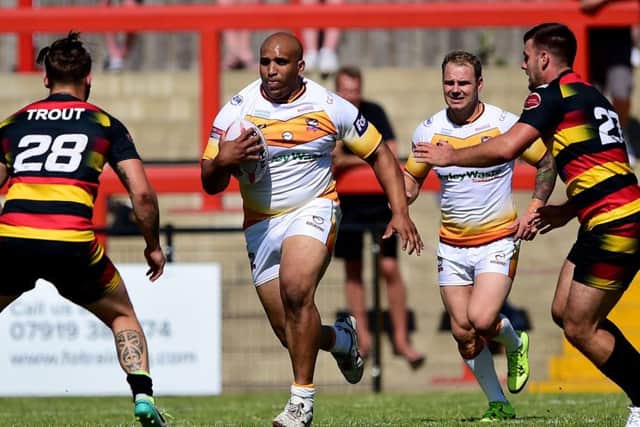 Dewsbury's Kyle Trout and Joe Arundel tackle Batley's Alex Rowe.