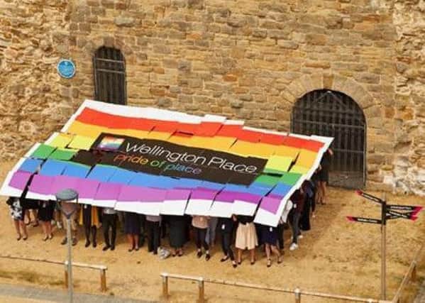 PRIDE OF PLACE: People from across the city created a giant flag in Tower Square.