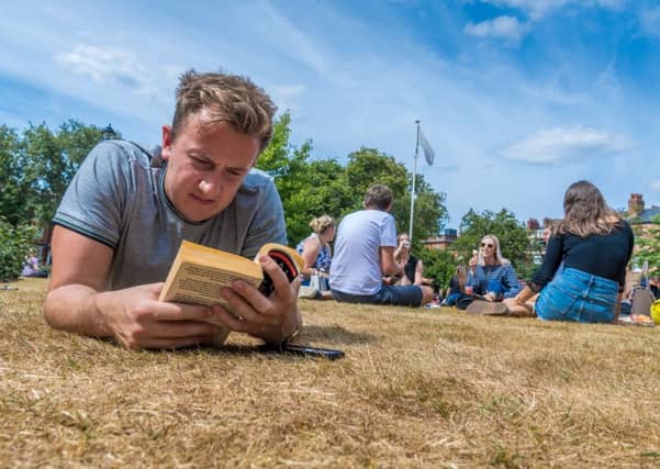 Dan Asquith enjoys the warm weather whilst in Park Square, Leeds. PIC: James Hardisty