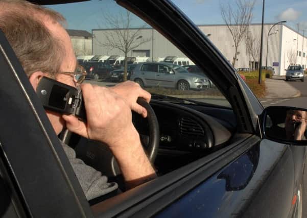 DISTRACTED: Brake says illegal phone use behind the wheel is all to common. Picture posed by model. Photo credit: Anna Gowthorpe/PA Wire