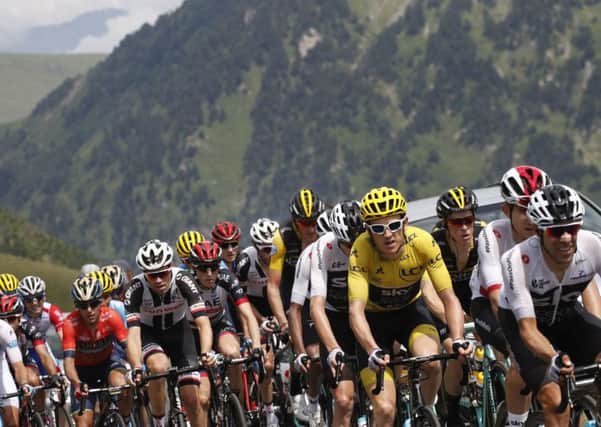 CLOSING IN: Spain's Jonathan Castroviejo, far right, sets the pace for Britain's Geraint Thomas, wearing the overall leader's yellow jersey. Picture: AP/Christophe Ena