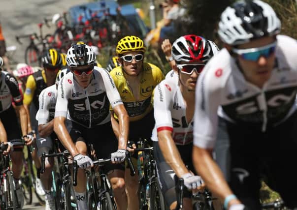 Britain's Chris Froome, center, and Britain's Geraint Thomas, wearing the overall leader's yellow jersey, climb Col d'Aspin pass during the nineteenth stage of the Tour de France. Picture: AP/Christophe Ena